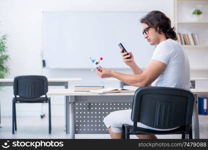 The young male student in front of whiteboard . Young male student in front of whiteboard