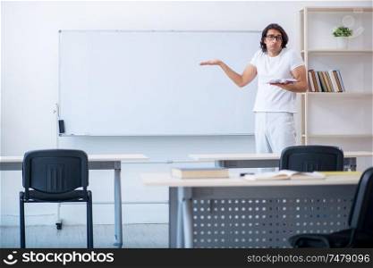 The young male student in front of whiteboard . Young male student in front of whiteboard