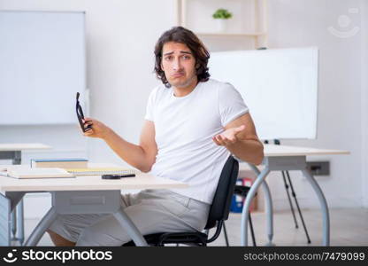 The young male student in front of whiteboard . Young male student in front of whiteboard