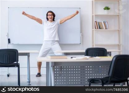 The young male student in front of whiteboard. Young male student in front of whiteboard
