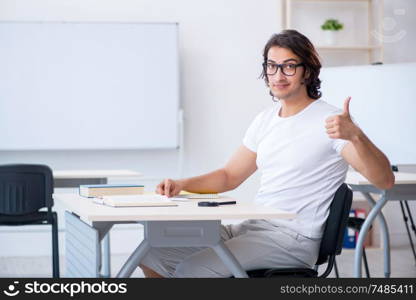 The young male student in front of whiteboard. Young male student in front of whiteboard