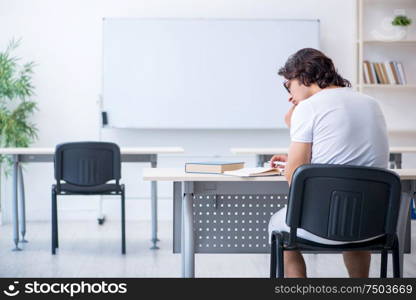 The young male student in front of whiteboard. Young male student in front of whiteboard