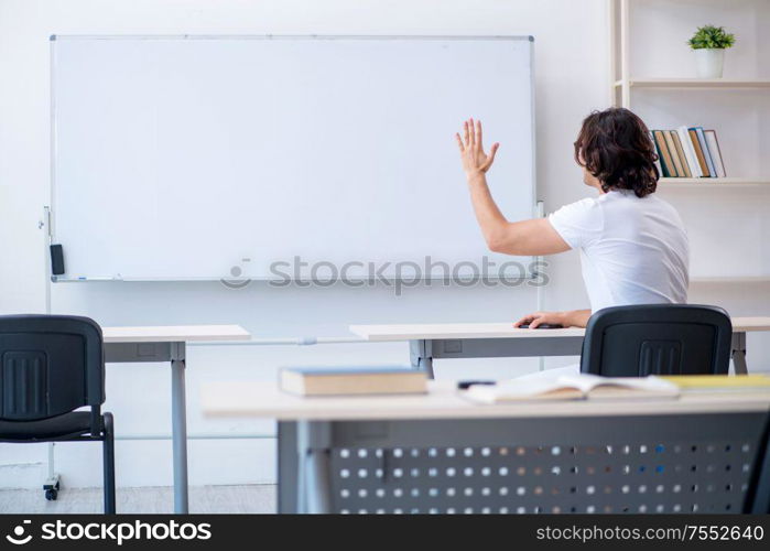 The young male student in front of whiteboard. Young male student in front of whiteboard