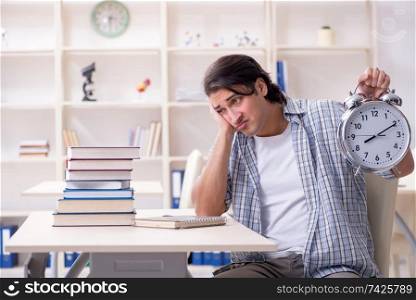 The young male student preparing for exams at home . Young male student preparing for exams at home 