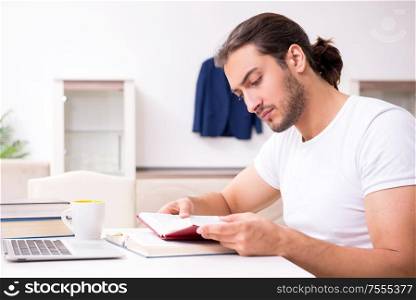 The young male student preparing for exams at home. Young male student preparing for exams at home