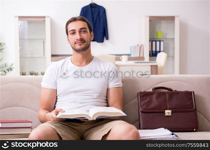 The young male student preparing for exams at home. Young male student preparing for exams at home