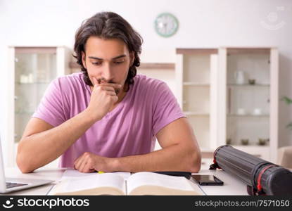 The young male student preparing for exams at home. Young male student preparing for exams at home