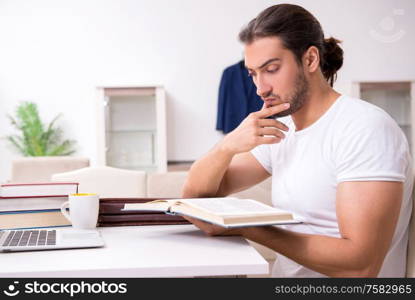 The young male student preparing for exams at home. Young male student preparing for exams at home