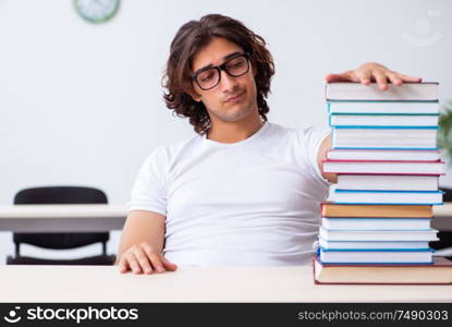 The young male student sitting in the classroom. Young male student sitting in the classroom