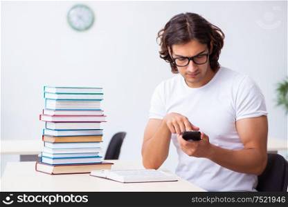 The young male student sitting in the classroom. Young male student sitting in the classroom