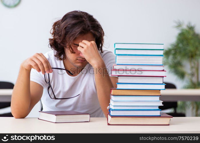 The young male student sitting in the classroom. Young male student sitting in the classroom