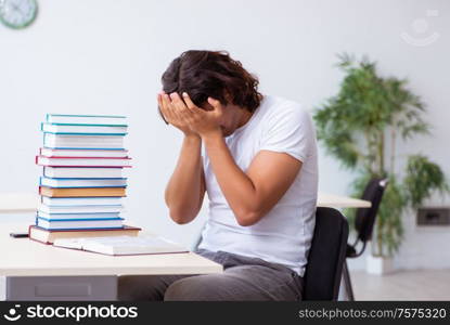 The young male student sitting in the classroom. Young male student sitting in the classroom