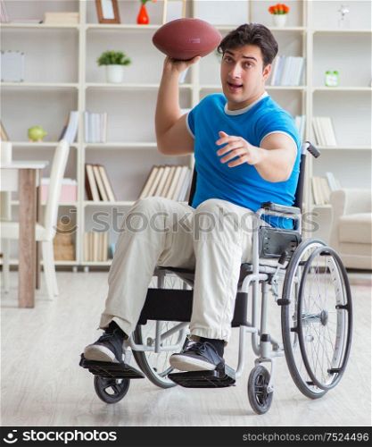 The young man american football player recovering on wheelchair. Young man american football player recovering on wheelchair