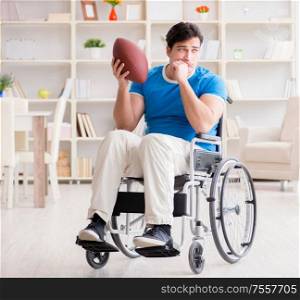 The young man american football player recovering on wheelchair. Young man american football player recovering on wheelchair