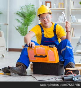 The young man assembling wood pallet. Young man assembling wood pallet