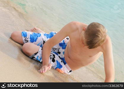 The young man bathes in the sea