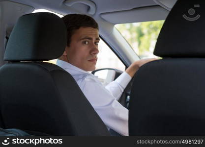 The young man behind the wheel driving car