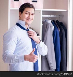 The young man businessman getting dressed for work. Young man businessman getting dressed for work
