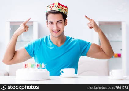 The young man celebrating birthday alone at home. Young man celebrating birthday alone at home