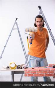 The young man contractor doing renovation at home . Young man contractor doing renovation at home