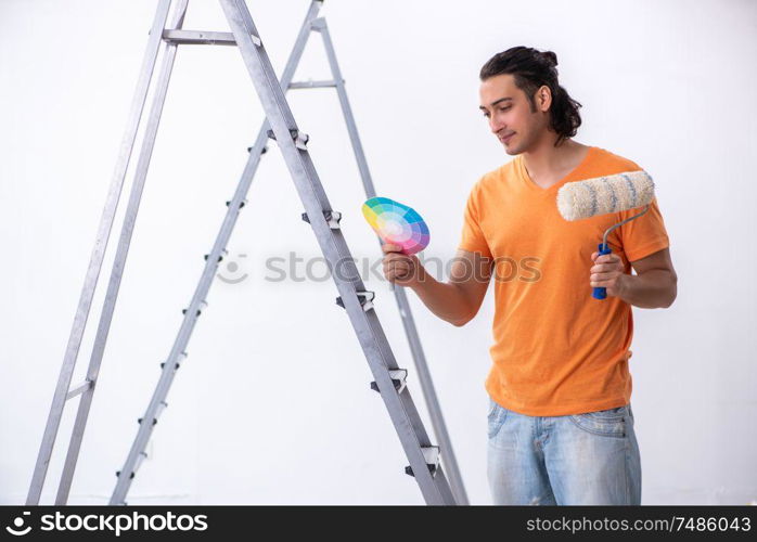 The young man contractor doing renovation at home. Young man contractor doing renovation at home