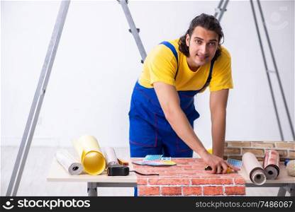The young man contractor doing renovation at home . Young man contractor doing renovation at home