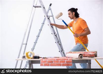 The young man contractor doing renovation at home. Young man contractor doing renovation at home