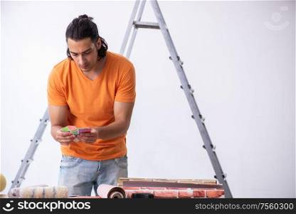 The young man contractor doing renovation at home. Young man contractor doing renovation at home