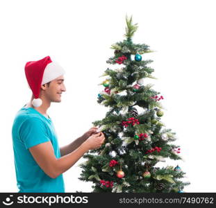 The young man decorating christmas tree isolated on white. Young man decorating christmas tree isolated on white