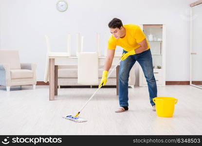 The young man doing chores at home. Young man doing chores at home