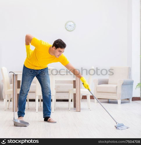 The young man doing chores at home. Young man doing chores at home