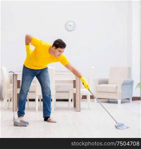 The young man doing chores at home. Young man doing chores at home