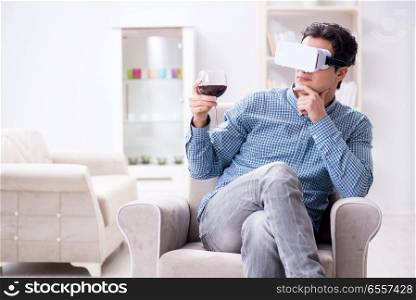 The young man drinking wine at home. Young man drinking wine at home