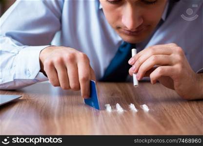 The young man having problems with narcotics at workplace . Young man having problems with narcotics at workplace