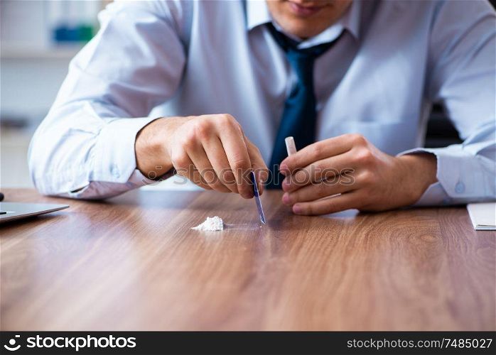 The young man having problems with narcotics at workplace . Young man having problems with narcotics at workplace