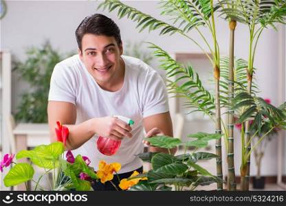 The young man in gardening concept at home. Young man in gardening concept at home