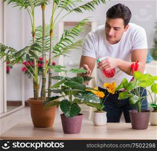 The young man in gardening concept at home. Young man in gardening concept at home