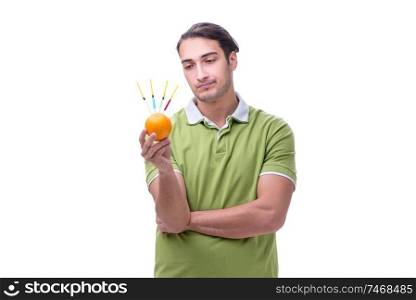 The young man in gmo fruits and vegetables concept. Young man in GMO fruits and vegetables concept