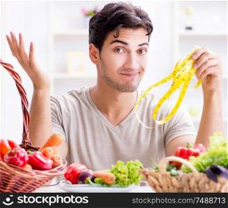 The young man in healthy eating and dieting concept. Young man in healthy eating and dieting concept