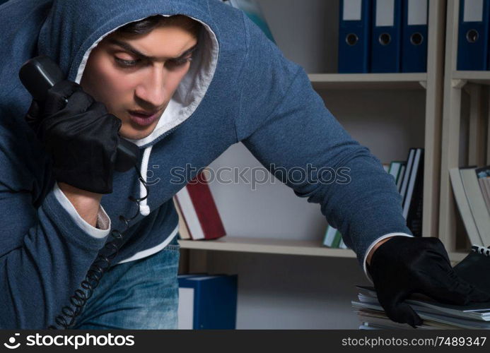 The young man in industrial espionage concept. Young man in industrial espionage concept