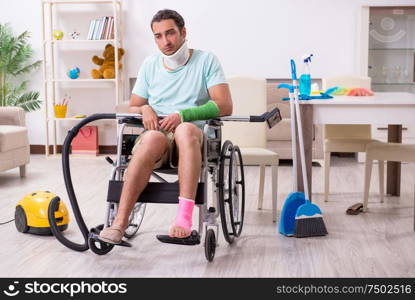 The young man in wheel-chair cleaning the house. Young man in wheel-chair cleaning the house