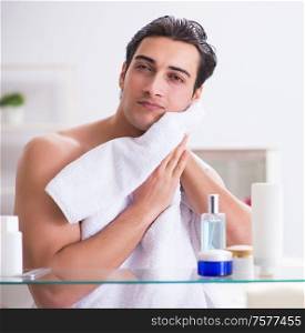 The young man is getting prepared for working day in bathroom. Young man is getting prepared for working day in bathroom