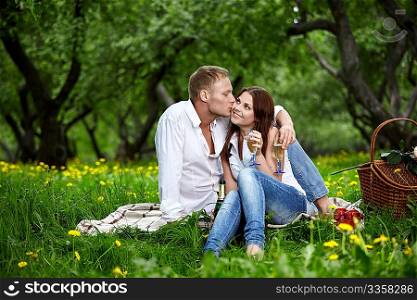 The young man kisses the girl in park