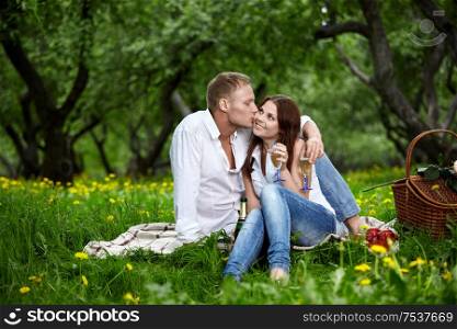 The young man kisses the girl in park