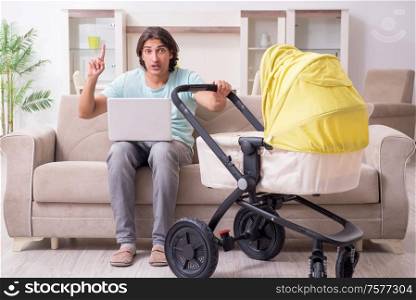 The young man looking after baby in pram. Young man looking after baby in pram