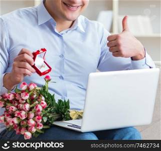 The young man making marriage proposal over internet laptop. Young man making marriage proposal over internet laptop
