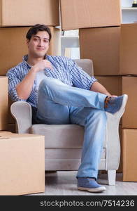 The young man moving in to new house with boxes. Young man moving in to new house with boxes