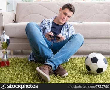 The young man playing computer games at home. Young man playing computer games at home