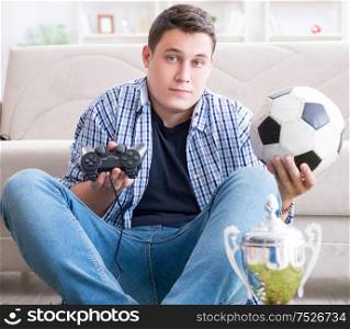 The young man playing computer games at home. Young man playing computer games at home