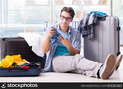 The young man preparing for vacation travel. Young man preparing for vacation travel